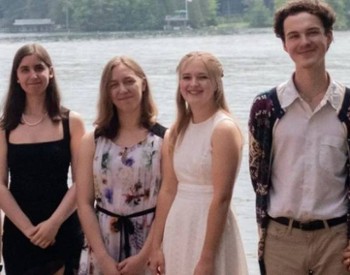 young people pose by water