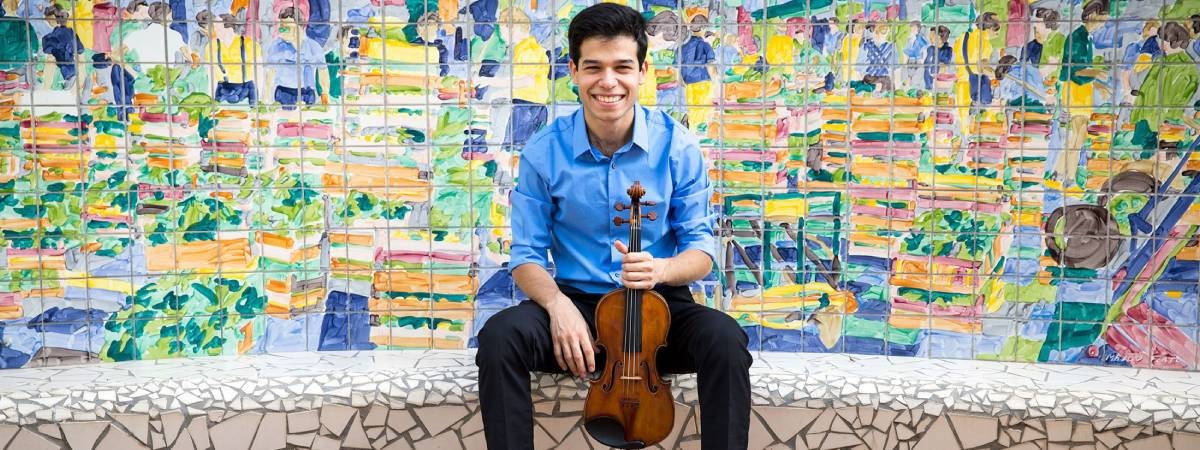 man poses with violin