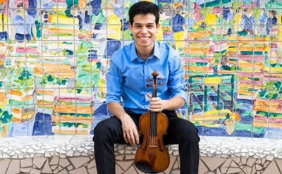 man poses with violin