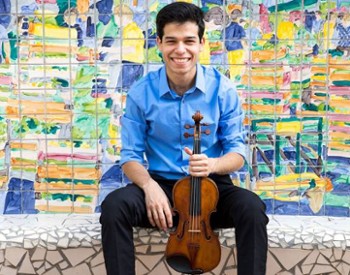 man poses with violin