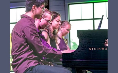 four people at piano