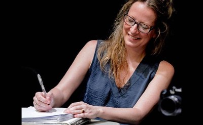 woman writing in notebook