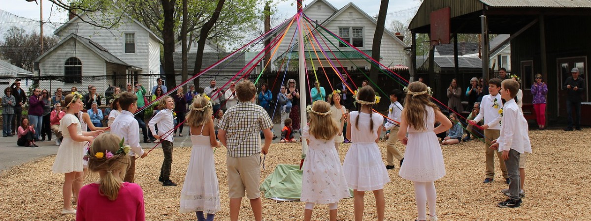 children dance around a maypole
