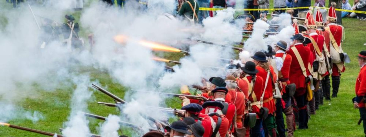 group of reenactors firing muskets