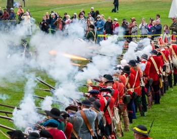 group of reenactors firing muskets