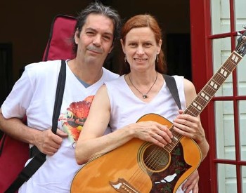 Tom Staudle on the left and Cosby Gibson on the right holding a guitar.