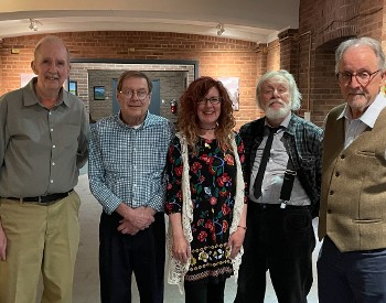 smiling people, four men and one woman