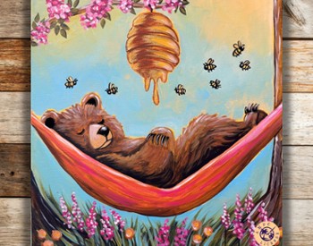 A bear sleeping in a hammock under a bee hive
