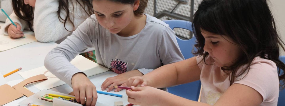Children using colored pencils.