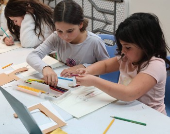 Children using colored pencils.