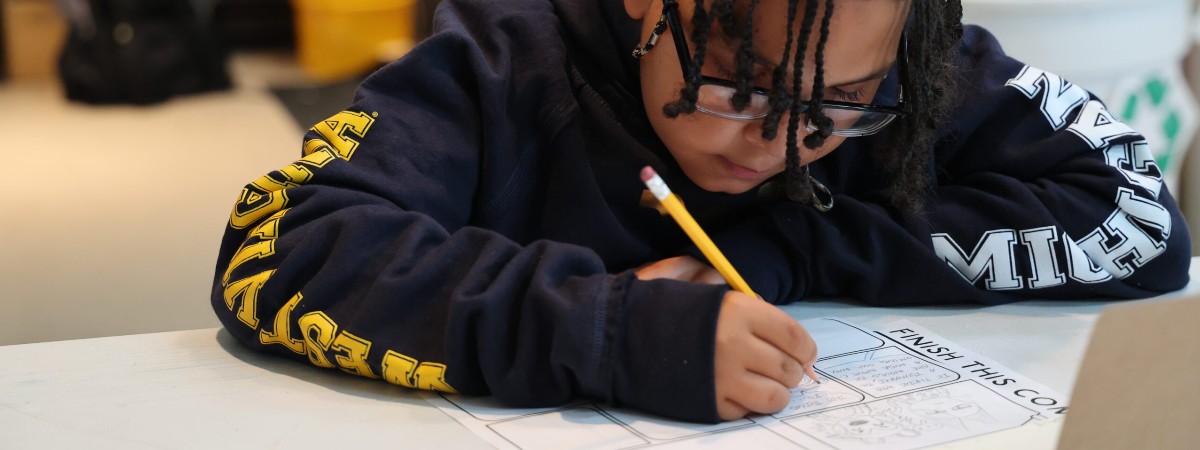 A child works on a graphic novel at The Hyde.