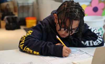 A child works on a graphic novel at The Hyde. 