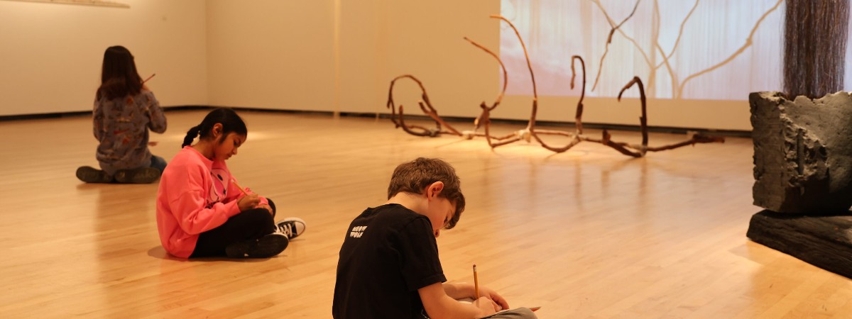 Children work in sketchbooks in The Hyde Collection.