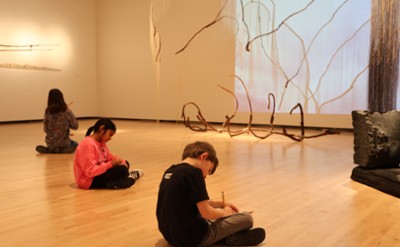 Children work in sketchbooks in The Hyde Collection. 