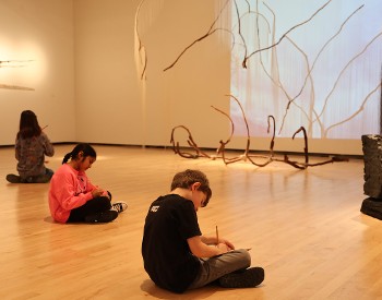 Children work in sketchbooks in The Hyde Collection.
