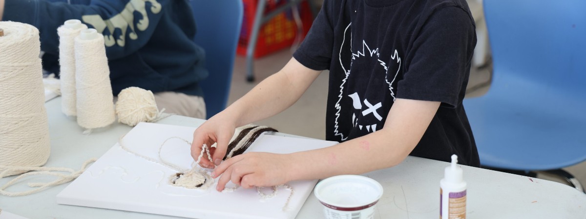 A child creates an artwork at The Hyde.