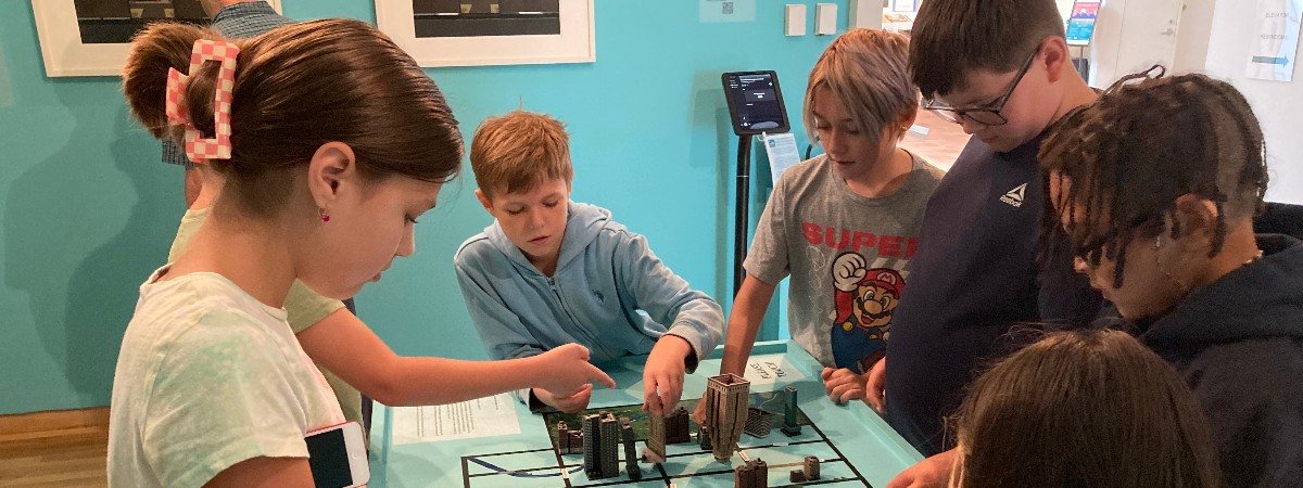 Children play with a city model at The Hyde Collection.