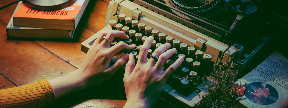 Hands on the keys of an antique typewriter