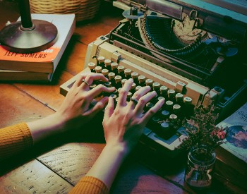 Hands on the keys of an antique typewriter