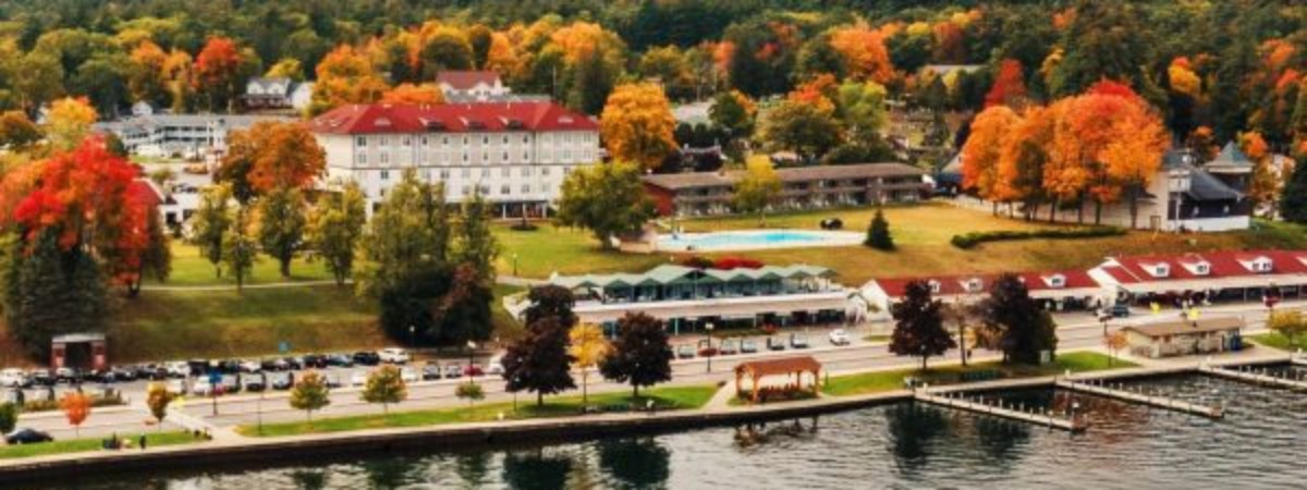 mohican steamboat on lake with fall colors on trees