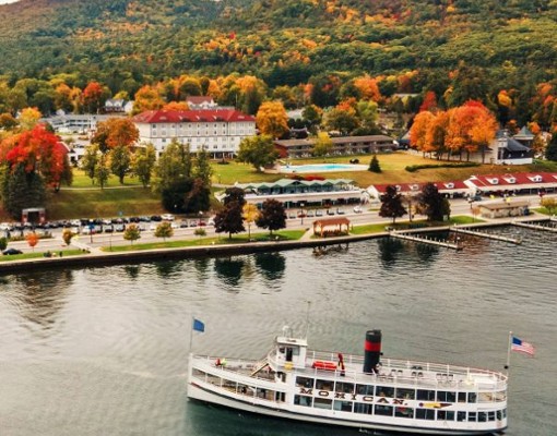 mohican steamboat on lake with fall colors on trees