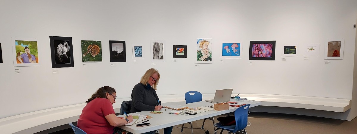 Participants writing at The Hyde Collection