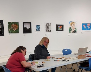 Participants writing at The Hyde Collection