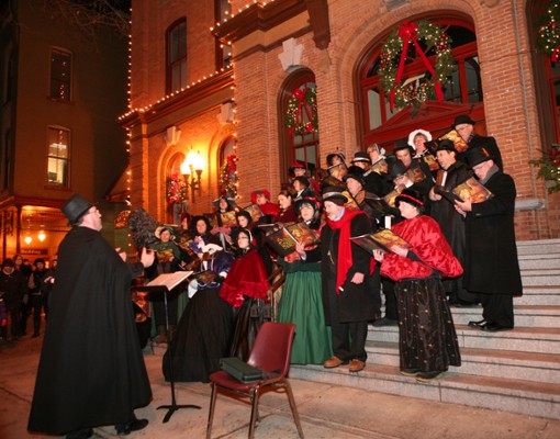 man leading carolers on church steps