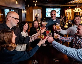 group cheers in a bar