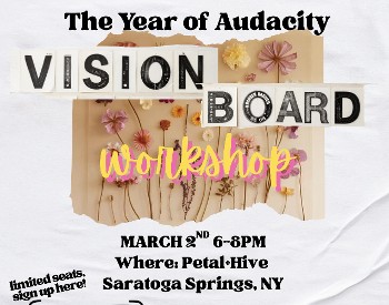 Words say Vision Board Workshop with flowers on a wooden board in the background