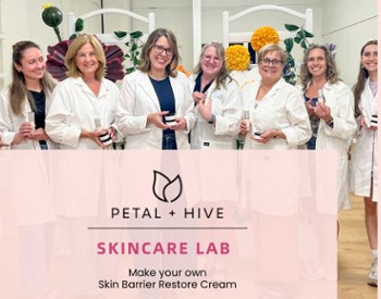 Women standing in a row wearing lab coats