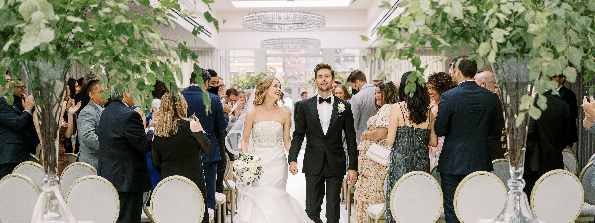 Couple walking down the aisle at The Adelphi Hotel