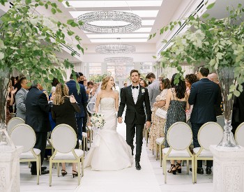 Couple walking down the aisle at The Adelphi Hotel
