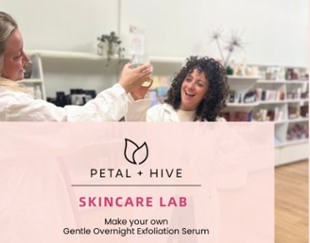 Women wearing lab coats and celebrating