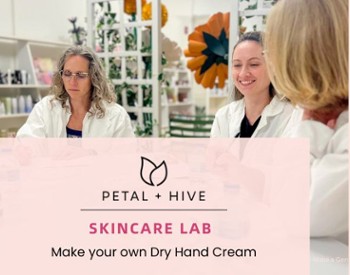 Women sitting at a table wearing lab coats