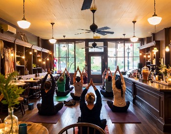 People sitting on the floor practicing yoga