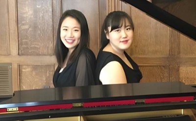 two women at piano