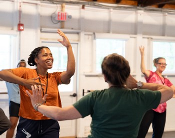 Curriculum in Motion participants dance in a well lit studio