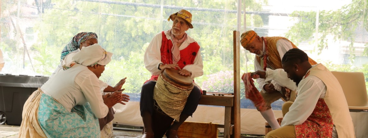 Performers dancing to a drum