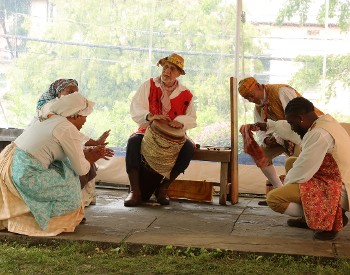 Performers dancing to a drum