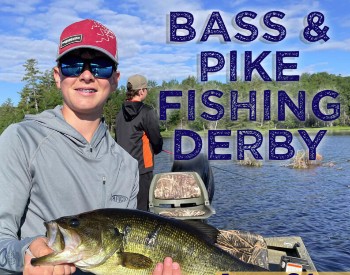 A young man in a boat holds up a large bass