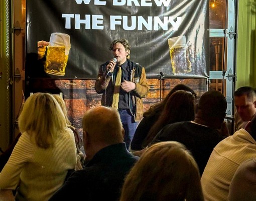 Live stand-up comedy performance at Artisanal Brew Works in Saratoga Springs