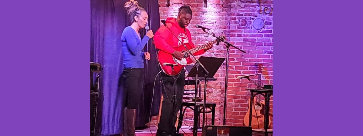 Two people performing on the Caffe Lena stage