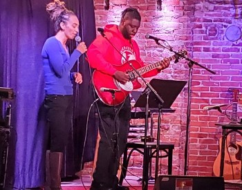 Two people performing on the Caffe Lena stage