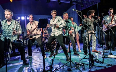 A large band plays and sings on stage