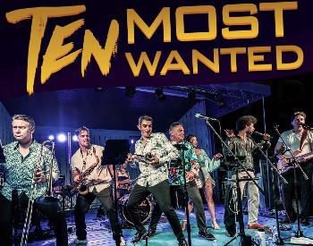 A large band plays and sings on stage