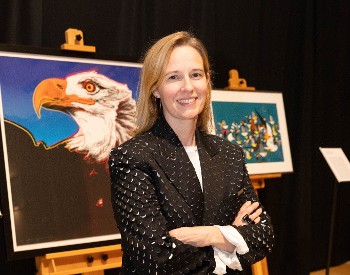 Jennifer Tafe in front of artwork from Museum of American Bird