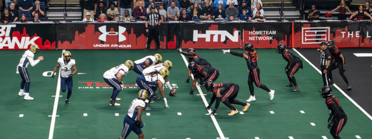 Albany Firebirds arena football on the field at line of scrimmage.