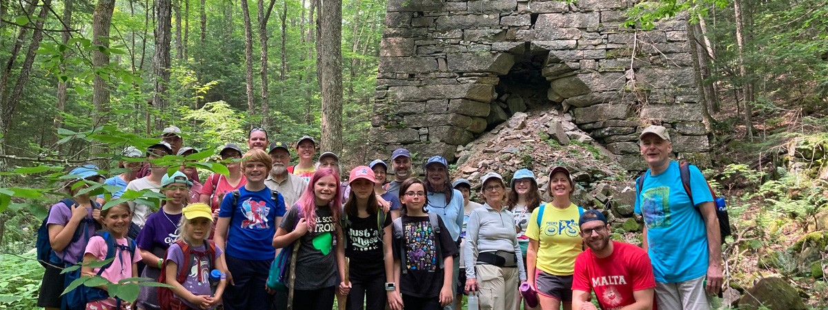 Tour group standing in front of historic Mount Hope Furnace