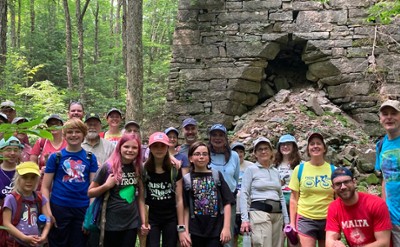 Tour group standing in front of historic Mount Hope Furnace
